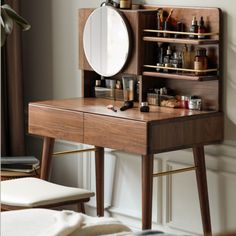 a wooden desk with a mirror on it and other items sitting on top of it