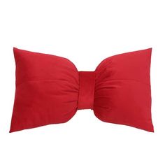 a red pillow with a large bow on it's side, isolated against a white background