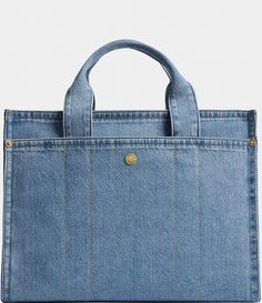 a denim bag with gold hardwares on the handles