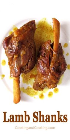 two lamb shanks on a plate with some bread