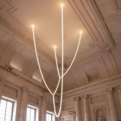 a chandelier hanging from the ceiling in a large room