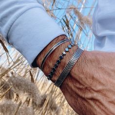 Three different bracelets for men. A unique wide bangle that is made from sterling silver 925, a hematite beaded bracelet at the middle and finally a metal thin bangle. You can wear them all together or separetely as well. Find them only at Christina Christi Store. 👉 My Mens Bracelets Collection: https://etsy.me/2UunKla 👉 Express Shipping: https://etsy.me/3ikUnOM MATERIALS - Hematite Beads  - Elastic cord. - Metal Thin made from brass (3mm - 1,18'') Bangle (there is a decoration hole at the ed Bangle Bracelets Silver, Men Bangle, Green Gemstone Bracelet, Prayer Jewelry, Pyrite Bracelet, Bracelets Men, Personalized Leather Bracelet, Bracelets Beaded, The Bangles