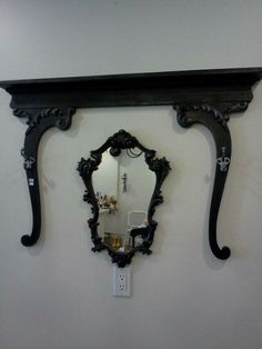 an ornate mirror and shelf on the wall