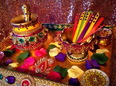 an elaborately decorated tray with lots of colorful items on it's sides and gold sequins around the edges