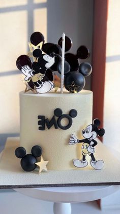 a birthday cake with mickey mouse decorations on it