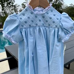 This Is A Beautiful Linen Dress In A Baby Blue Color With With Lace Around The Collar And Sleeves. The Chest Of The Dress Has Woven Flowers In A Squared Stitched Pattern. The Back Buttons At The Neck With 2 White Buttons. This Item Is A Size 2 But I Will Be Listing The Entire Size Run So If You Need To Match Sisters Or Cousins For Easter Or Perhaps To Be In A Wedding, I Might Have Your Sizes. All Items Are Direct From The Maker And They Are First Run Items Through My Boutique. Cotton Short Sleeve Dress For Baptism, Blue Cotton Dress For Baptism, Fitted Light Blue Dress For Dress-up, Cute Light Blue Dress For Daywear, Cotton Baptism Dress With Lining, Light Blue Cotton Baptism Dress, Light Blue Cotton Dress For Baptism, Blue Cotton Dresses With Short Sleeves, Cute Blue Dress With Lace Trim