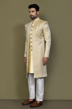 Gold and yellow full sleeves layered sherwani crafted in jacquard silk with prism helix pattern detailing on the outer layer and plain front button detail inner layer. Paired with a cream Aligadhi pant. - Aza Fashions Yellow Sherwani With Cutdana In Straight Kurta Style, Yellow Sherwani With Zari Work And Traditional Drape, Festive Yellow Bandhgala With Cutdana, Yellow Kurta With Naqshi For Wedding, Yellow Naqshi Kurta For Wedding, Yellow Bandhgala With Zari Work In Traditional Drape, Yellow Traditional Drape Sherwani, Yellow Cutdana Bandhgala For Wedding, Gold Sherwani With Cutdana In Straight Kurta Style