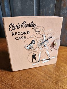 an elvis presley record case sitting on top of a wooden table