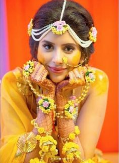 a woman in yellow is posing for the camera