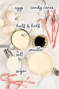 the ingredients to make an eggnog recipe on a marble counter top with candy canes