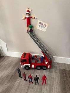 an elf is standing on top of a fire truck