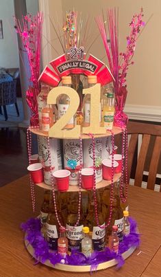 a tiered display with bottles and condiments for a 21st birthday party on a table