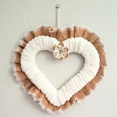 a heart shaped wreath hanging on the wall