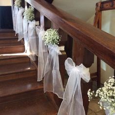 flowers are tied to the banisters on the stairs