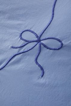 an embroidered blue cloth with a knot on it