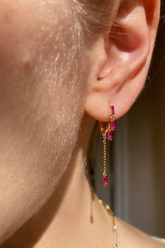 Our tiniest huggies made of 14K vermeil cz with 4 dangling tiny pink sapphire cz gemstones and tiny chain. So cute an everyday earring or as an addition to your ear game. Gem Earrings Gemstones, Ears Pirsing, Infinite Jewelry, Pink And Gold Jewelry, Bts Jewelry, Gemstones Earrings, Pink Ruby, Dope Jewelry, Ruby Earrings