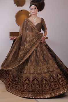 Brown lehenga with all over dome, floral embroidery including attached cancan. Comes with embroidered padded blouse and dupatta.
Component: 3
Pattern: Embroidery
Type Of Work: Floral, Dome
Neckline: Sweetheart
Sleeve Type: Half
Fabric: Raw Silk, Organza
Color: Brown
Other Details: 
Scallop border dupatta
Attached lining
Approx weight (in kgs) : 7 to 8
Closure: Lehenga - Drawstring
Occasion: Wedding - Aza Fashions Unstitched Lehenga With Intricate Embroidery For Festive Occasions, Festive Lehenga With Intricate Embroidery Unstitched, Embroidered Brocade Floor-length Sets, Embroidered Floor-length Brocade Sets, Organza Choli With Intricate Embroidery For Reception, Unstitched Tissue Silk Lehenga With Intricate Embroidery, Festive Tissue Silk Lehenga With Intricate Embroidery, Embroidered Organza Choli For Reception, Fitted Tissue Silk Choli With Intricate Embroidery