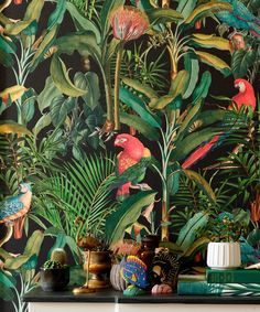 the wallpaper in this room is painted with tropical plants and birds on black background