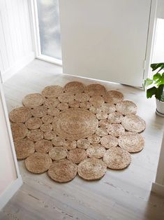 a door mat on the floor in front of a white door