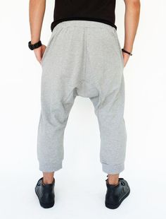 "🚚..ALL ORDERS ARE SHIPPED VIA DHL EXPRESS MAIL Harem-style sweatpants with a cropped profile. Made of stretch cotton-blend jersey, these cropped pants are comfortable to wear and easy to move in. * Pull-on style * Drop-crotch style * Elastic waistband with black drawstring * Side slant pockets * Ribbed ankle cuffs * Cropped length Measurements approximately: Waist: 27\" (68.5 cm) stretching to 48\" (122 cm) Hips: 50\" (127 cm) Outseam: 31\" (79 cm) In Front Rise: 17 1/2\" (44 cm) In Back Rise: Gray Baggy Pants With Elastic Waistband, Baggy Straight Hip Hop Pants, Sporty Cotton Harem Pants With Tapered Leg, Baggy Tapered Leg Bottoms With Elastic Waistband, Baggy Tapered Leg Loungewear Bottoms, Hip Hop Baggy Bottoms With Elastic Waistband, Baggy Bottoms With Elastic Waistband And Tapered Leg, Hip Hop Baggy Loungewear Pants, Baggy Tapered Leg Loungewear Pants