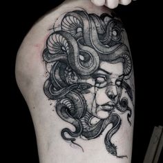 a woman's arm with a tattoo on it and an image of a snake wrapped around her head