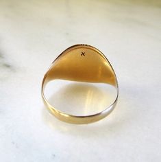 "This is a vintage 10K yellow gold signet ring. The ring is blank and ready to be engraved with your initial. There are 2 extremely shallow dents in the area where the engraving will most likely cover them or etch them out. The ring face measures 9/16\" long x 1/2\" wide. The band is sized at a 9 1/2. Total weight of the ring is 4.1grams/2.6dwt. This is a vintage, previously owned ring. Therefore, light wear can be expected. There is no visible damage." The Ring Face, Signet Rings, Cameo Ring, Gold Signet Ring, Tennis Bracelet Diamond, Signet Ring, Gold Bands, Gold Vermeil, Beautiful Rings