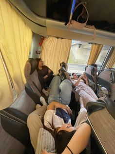 several people sleeping in the back of a bus