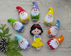 christmas ornaments with gnomes and pine cones on a table