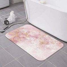 a bathroom with a bathtub and rug on the floor