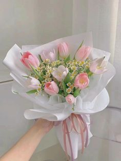 a bouquet of pink tulips and baby's breath