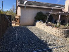 a house with gravel and rocks in front of it