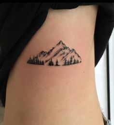 a small mountain tattoo on the right thigh