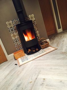 a wood burning stove sitting on top of a wooden floor