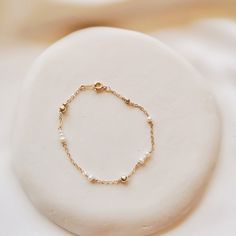 "DAINTY BRACELET | DELICATE PEARL BRACELET | DAINTY ANKLET | FRESHWATER PEARL BRACELET | 14K GOLD FILLED PEARL BRACELET | STERLING SILVER PEARL BRACELET | WHITE PEARL GOLD BRACELET | BRIDAL BRACELET | GOLD BRACELET |  Kira Mini Pearl Bracelet 🤍 S T Y L E 🤍 * Dainty bracelet with tiny freshwater pearls * Choose your preferred length 🤍 M E A S U R E M E N T S 🤍 * Length Bracelet: 17cm, 18cm, 19cm, or 15cm + 5cm extender (Please contact us if you wish to custom-made the length for your bracelet) * Pearl size approx. 1-3mm  🤍 M A T E R I A L S 🤍 * Pearl Freshwater Pearl * Metal Yellow Gold: 14k gold-filled  Silver: 925 Sterling Silver 🤍 P E R S O N A L I S E D 🤍 If you wish to have your jewelry made with other shapes or numbers of pearls, or if you wish to make any other modifications, Dainty Pearl Chain Bracelet With Jubilee Style, Delicate Beaded Round Bracelets, Delicate Bracelet With Adjustable Chain And Round Beads, Dainty Pearl Bracelet With Adjustable Beaded Chain, Adjustable Bracelet With Satellite Chain And Round Beads, White Dainty Chain Bracelet With Round Beads, Dainty Round Bracelets With Extender, Dainty White Chain Bracelet With Round Beads, Dainty White Round Beads Chain Bracelet