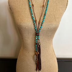 Turquoise Clutch Necklace Horn and Deerskin Tassel. Hand crafted by Amy Kaplan. Amy is a truly talented artisan who has been hand crafting high quality custom jewelry for cowgirls with discriminating taste. You'll have a unique custom piece of western jewelry that stands out from the crowd. Turquoise, golden and olive horn beads with natural horn feather shaped pendant and deerskin tassel. Bohemian Lariat Necklace With Tassels, Adjustable Turquoise Jewelry With 108 Beads, Turquoise Multi-strand Hand Wrapped Jewelry, Artisan Hand Wrapped Turquoise Necklaces, Artisan Turquoise Hand Wrapped Necklaces, Turquoise Tassel Necklaces For Festivals, Adjustable Artisan Turquoise Necklace, Turquoise Beaded Necklaces With Tassels For Gift, Hand-strung Multi-strand Bohemian Turquoise Necklace