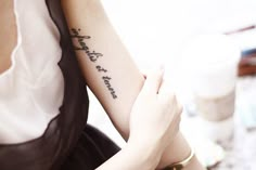 a woman with a tattoo on her arm that reads, i love you to the moon and back