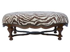 a zebra print bench with wooden legs and an upholstered cushion on the top