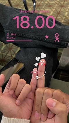 two hands holding onto each other with numbers on them and hearts drawn on their fingers