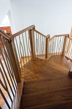 the stairs are made of wood and have metal railings