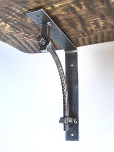 a skateboard mounted to the side of a wall with a metal hook on it