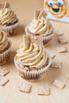 cupcakes with frosting and crackers on a table