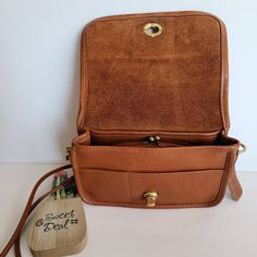 "Vtg Classic Original Coach Kisslock Dinky Leather with brass hardware Roomy interior with 1 slip pocket, attached kisslock coin pouch, outer slip pocket divided in two covered by a flap and secured with a turnlock Detachable 39\" strap Measures: 8\"L, 5\"H, 2\"W Made in New York, USA #348-4644 Flaws: 2 slots of leather in front, stains on front and stains on top and back Cleaned, conditioned and ready to wear! Questions? Just ask More vtg coach colors/styles also available Rc029" Crossbody Saddle Bag With Brass Hardware For Travel, Travel Crossbody Flap Bag With Brass Hardware, Retro Crossbody Bag With Brass Hardware, Crossbody Flap Bag With Brass Hardware For Travel, Classic Flap Bag With Leather Lining For Everyday, Brass Hardware Crossbody Flap Bag For Travel, Classic Saddle Bag With Brass Hardware, Classic Flap Saddle Bag For Everyday Use, Classic Leather Lined Crossbody Saddle Bag