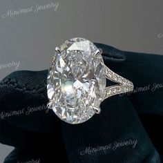 an oval cut diamond ring with pave diamonds on it