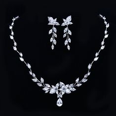 A beautiful two-piece bridal jewelry set with an incredible sparkle! Adorned with intricately faceted cubic zirconia that capture the light from every angle with a perfectly translucent appeal, the pieces are platinum plated for a flawless finish which enhances the intricate detailing and conveys a modern take on old elegance. Necklace: 17" (approx. 43cm) long with a secure fold-over closure Earrings: 1.5" (approx. 4cm) long and come with sturdy backs Hypoallergenic - lead, nickel and cadmium fr White Gold Jewelry Sets With Diamond Accents And Crystal, White Crystal Bridal Sets With Elegant Design, White Crystal Bridal Sets With Diamond Cut, White Crystal Bridal Sets With Sparkling Stones, Silver Crystal Jewelry Set With Brilliant Cut, Dazzling White Crystal Bridal Sets, Silver Cubic Zirconia Bridal Accessories, Elegant Silver Bridal Sets With Rhinestones, White Bridal Necklace With Rhinestones