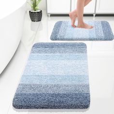 two bathroom rugs with feet on the floor