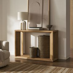 a living room with a couch, mirror and two wicker baskets on the floor