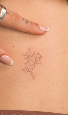 a close up of a person's stomach with a tattoo on the back of her body