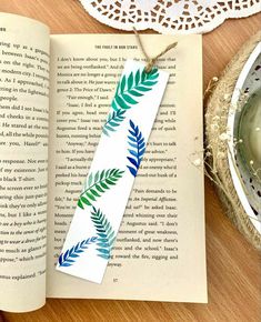 an open book with a green leaf on it