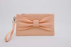 a pink purse with a bow on the front