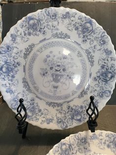 two blue and white plates sitting next to each other